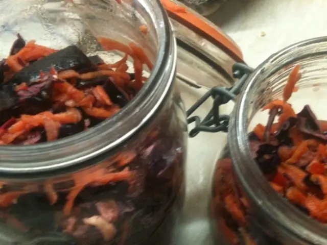 In this image in the center there is food in the jars.