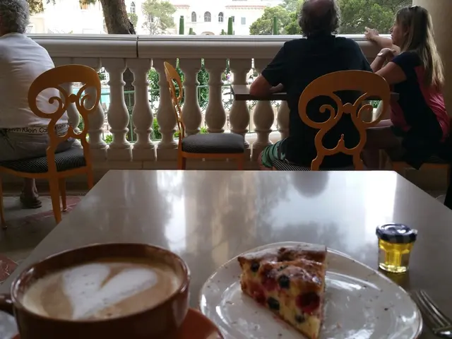 This picture is old man sitting on a chair table in front of him and also this table which has a...