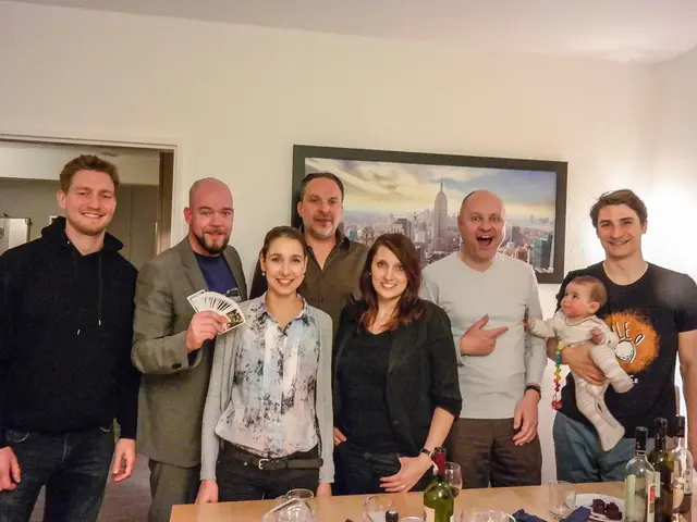 In the image we can see there are people standing, wearing clothes and they are smiling, on the...