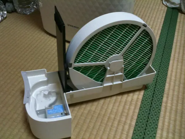 In this image I can see a machine d is placed on a mat. Behind this there is a box and also I can...